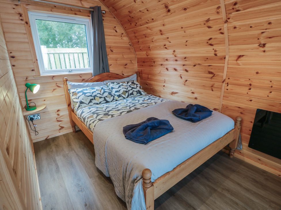 A bedroom with a bed and table lamp at Douglas near Stoneykirk