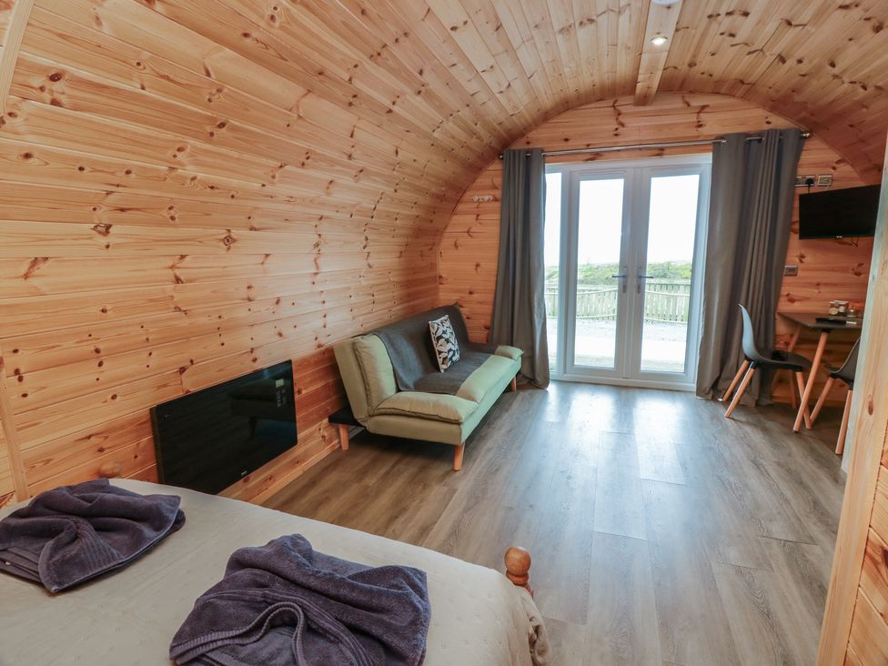 A living room with a sofa and television at Douglas in Stoneykirk near Sandhead