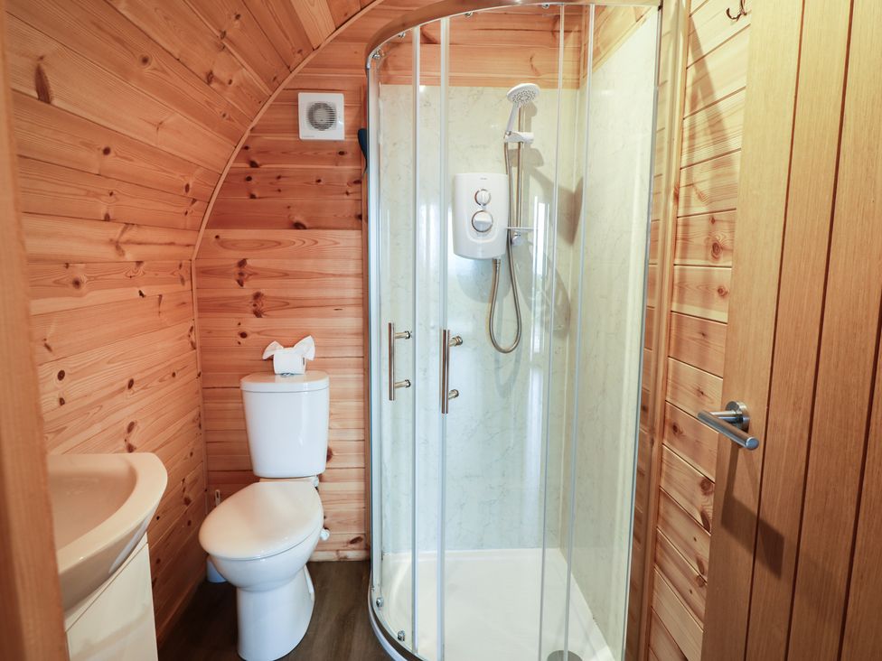 A bathroom featuring a shower and toilet at Douglas in Stoneykirk near Sandhead