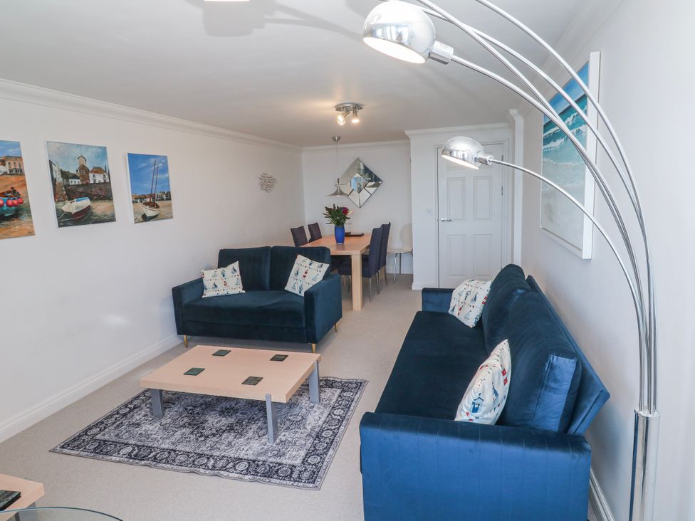A living room with sofas and a dining area at 21 Compass Point Carbis Bay