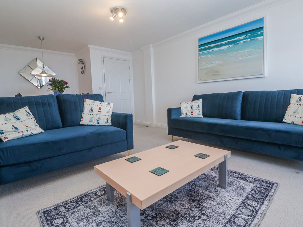 A living room with sofas and a coffee table at 21 Compass Point in Carbis Bay