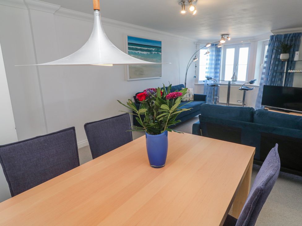 A dining room with a table and chairs at 21 Compass Point Carbis Bay