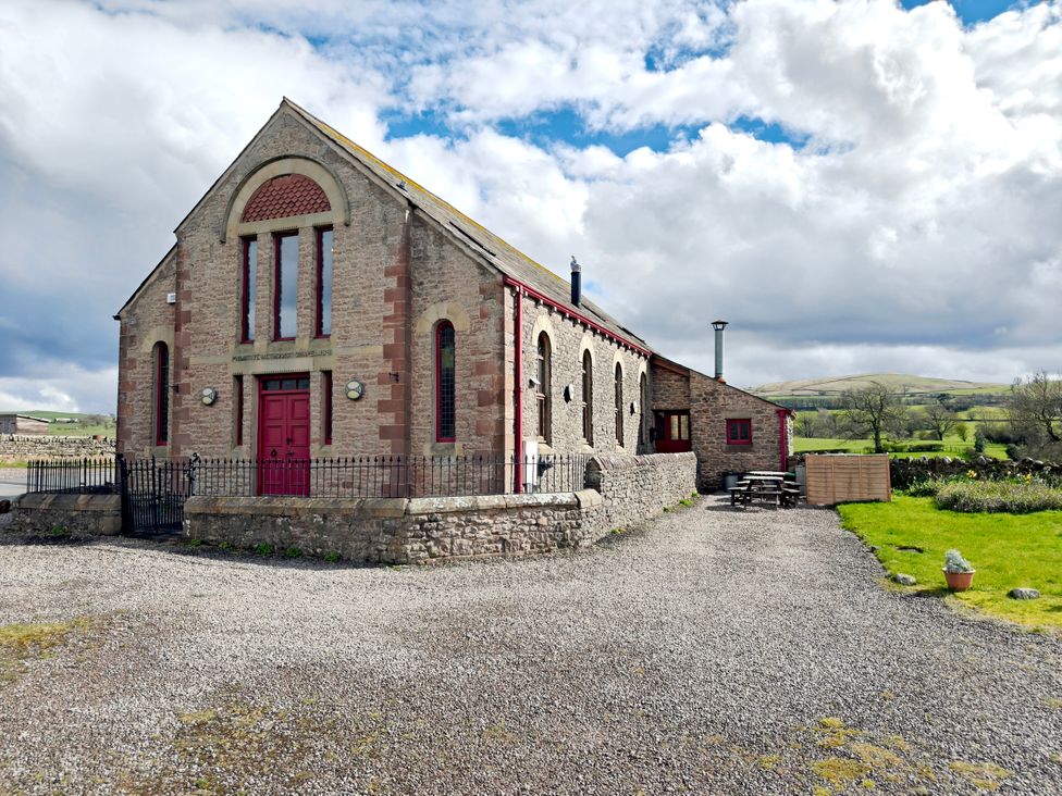 A building with parking area and outdoor seating at Kaber Chapel in Kaber near Kirby Stephen
