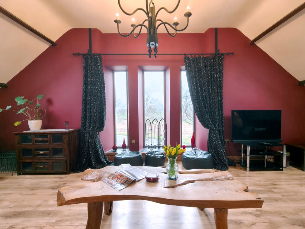 A living room with large windows and a coffee table at Kaber Chapel near Kirby Stephen