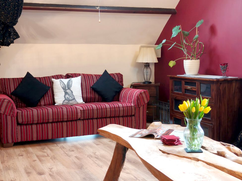 A living room with a sofa and a table at Kaber Chapel in Kaber near Kirby Stephen