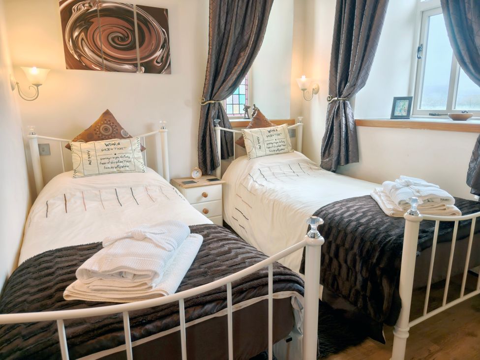 A bedroom with two beds and a nightstand at Kaber Chapel in Kaber near Kirby Stephen