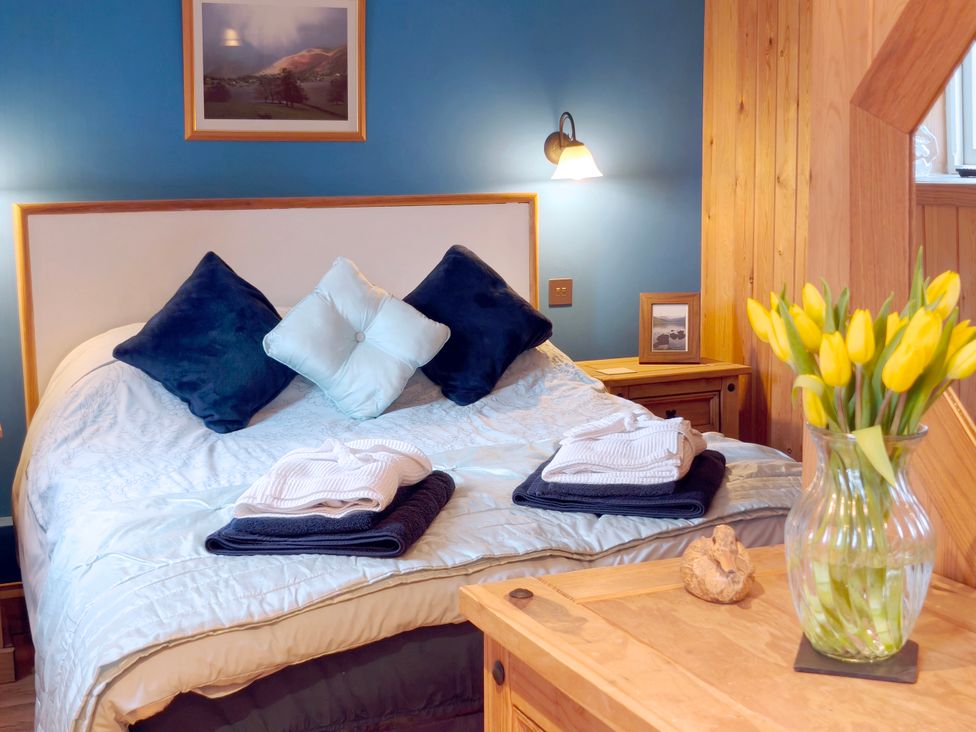 A bedroom with a bed and flowers at Kaber Chapel in Kaber near Kirby Stephen