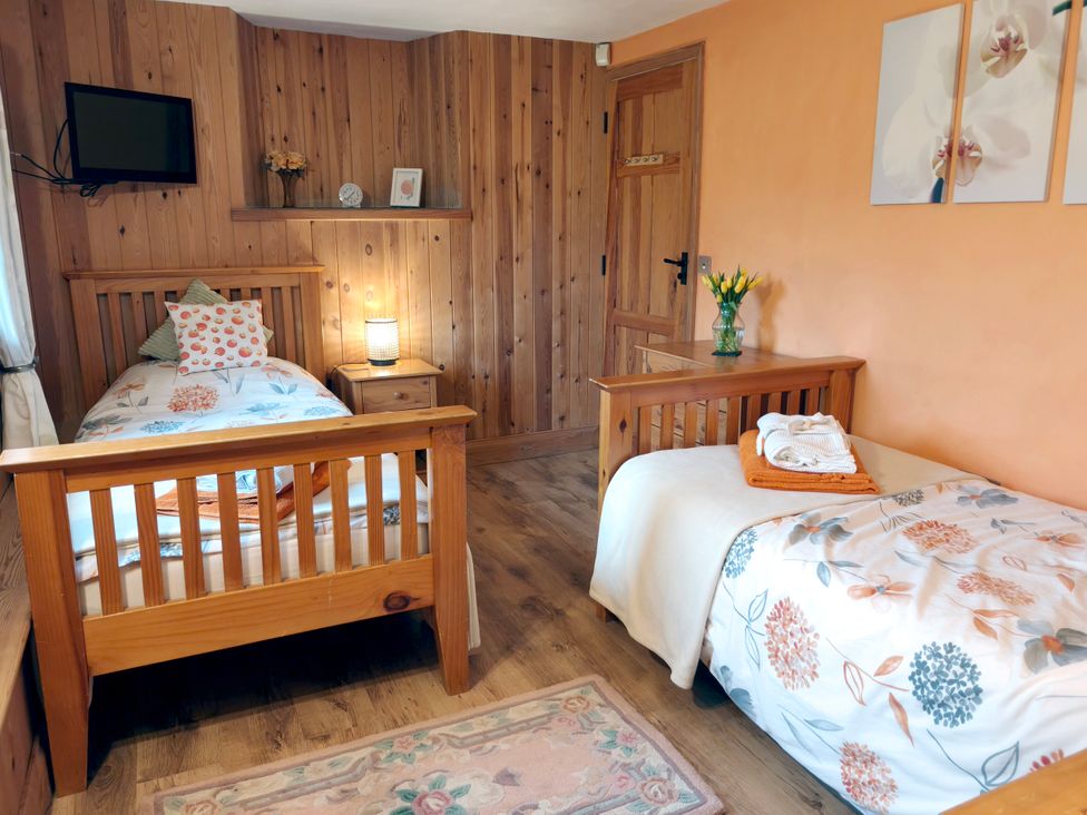 A bedroom with twin beds and a television at Kaber Chapel in Kaber near Kirby Stephen
