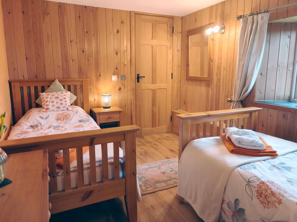 A bedroom with two beds and a nightstand at Kaber Chapel in Kaber near Kirby Stephen