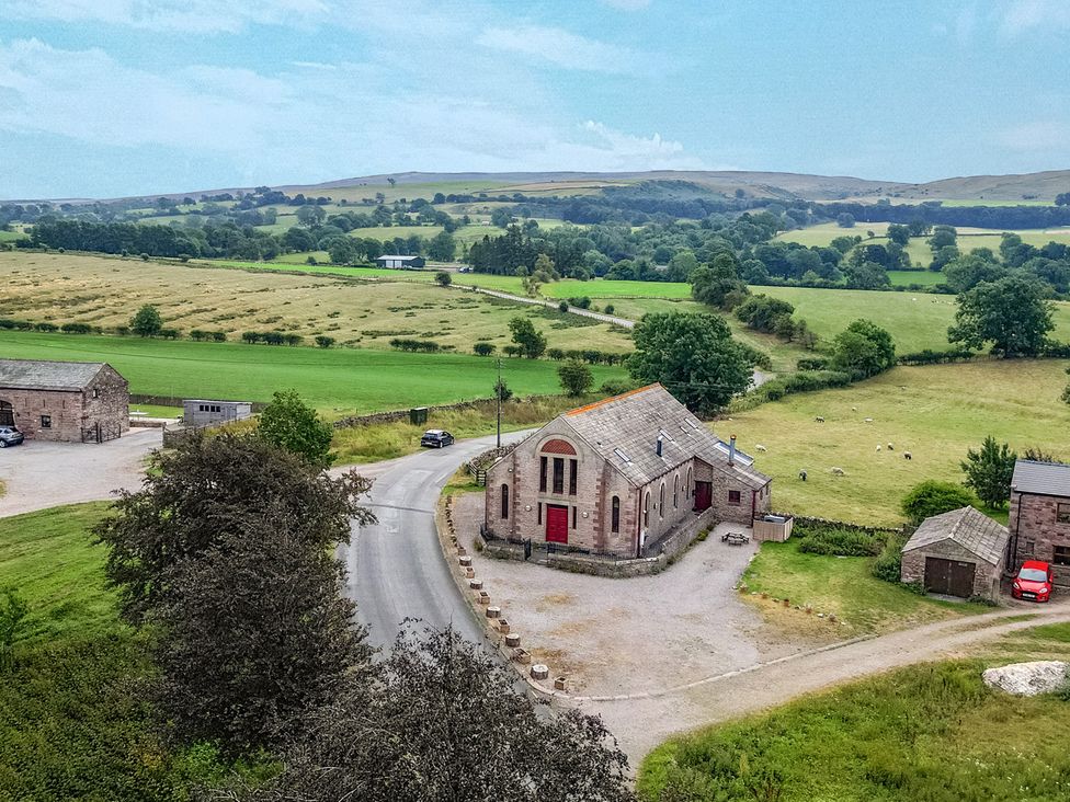 An exterior view of a building near a road with fields in the background at Kaber Chapel in Kaber near Kirkby Stephen