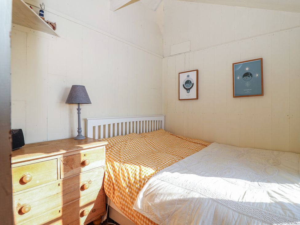 A bedroom with a bed and lamp at The Cabin 