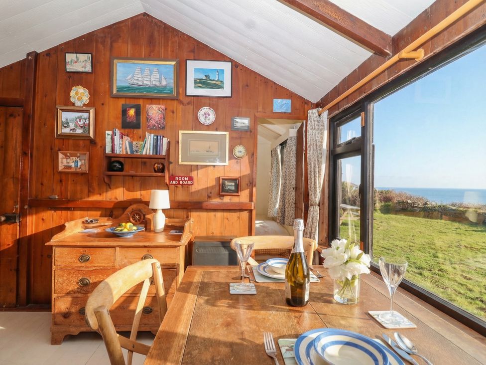 A dining room with a table set for meals at The Cabin 