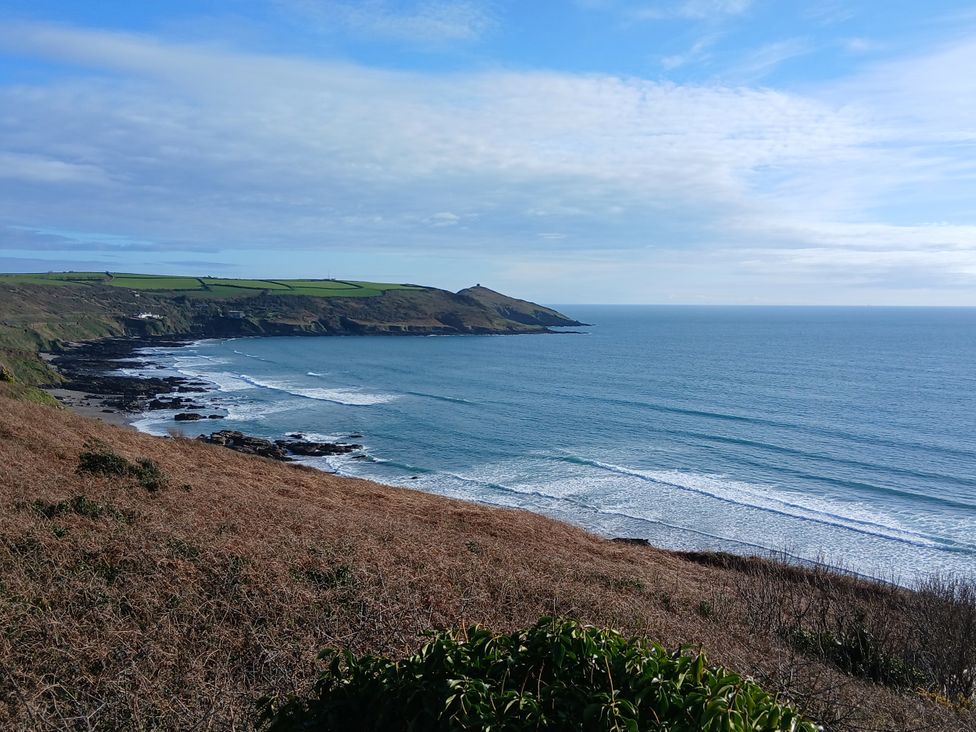 A coastal view with waves and hills at The Cabin in 
