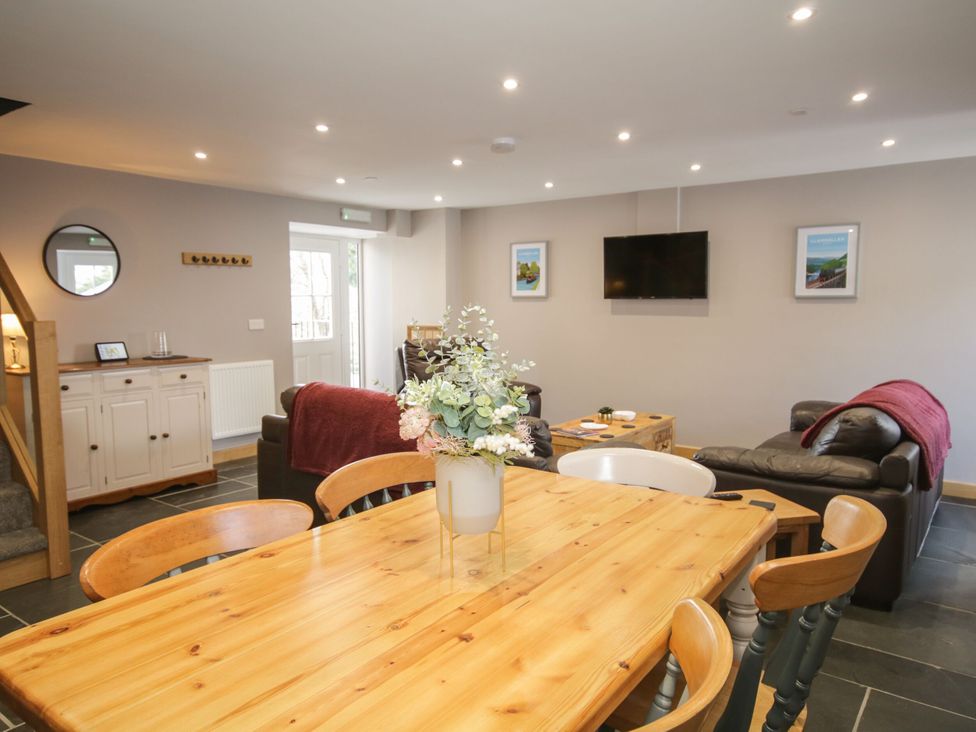 A living room with a dining table and sofa at Sun Trevor Barns 2 Llangollen