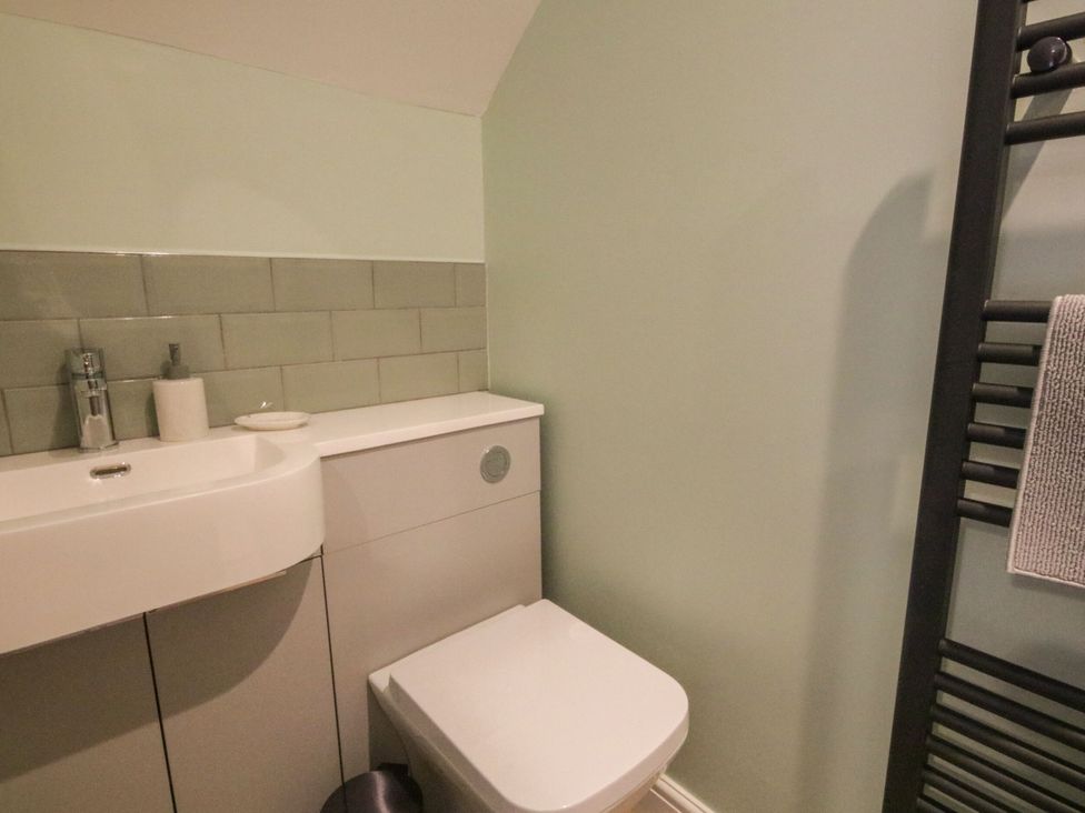 A bathroom with a sink and toilet at Sun Trevor Barns 2 Llangollen