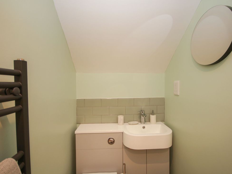 A bathroom with a sink and mirror at Sun Trevor Barns 2 in Llangollen