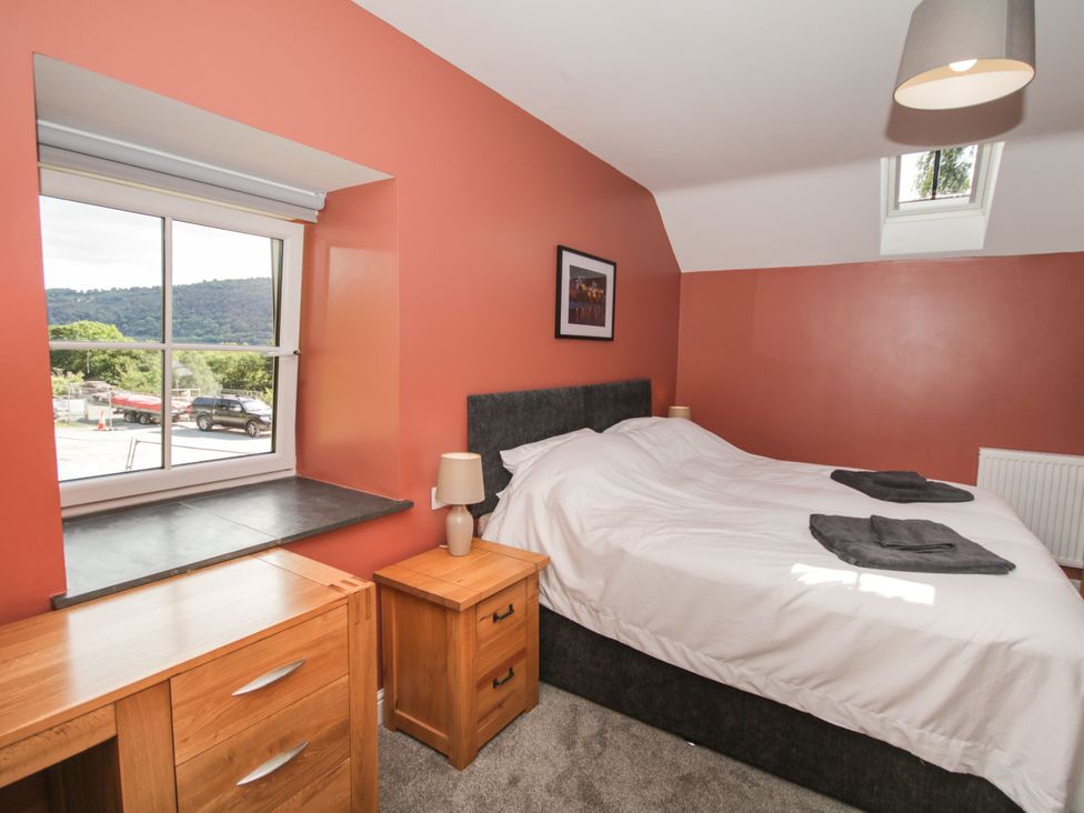 A bedroom with a bed and desk at Sun Trevor Barns 3 Llangollen