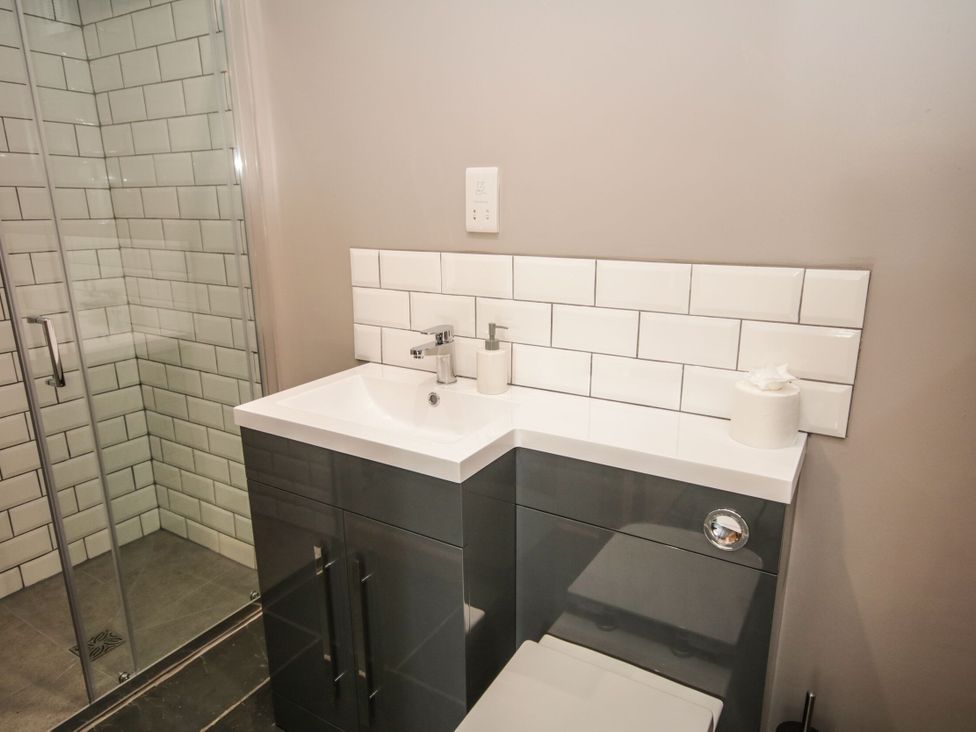 A bathroom with a sink and toilet at Sun Trevor Barns 3 in Llangollen