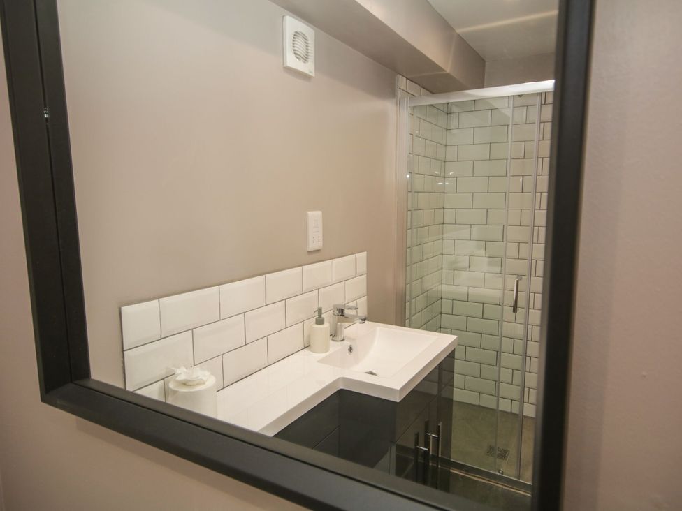 A bathroom with a sink and shower at Sun Trevor Barns 3 Llangollen