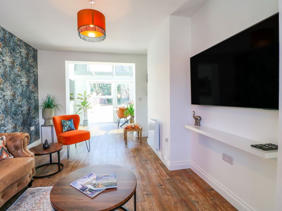 A living room with a sofa and coffee table at 19 Berry Avenue in Breedon On The Hill