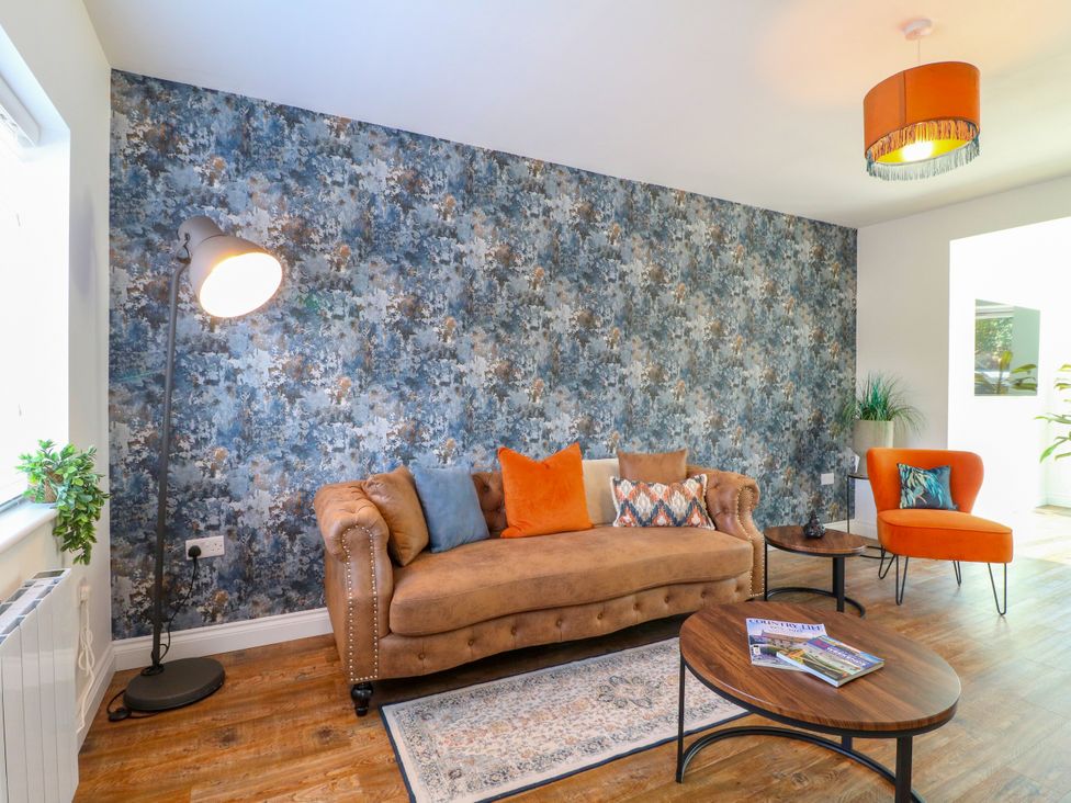 A living room with a sofa and coffee table at 19 Berry Avenue Breedon On The Hill