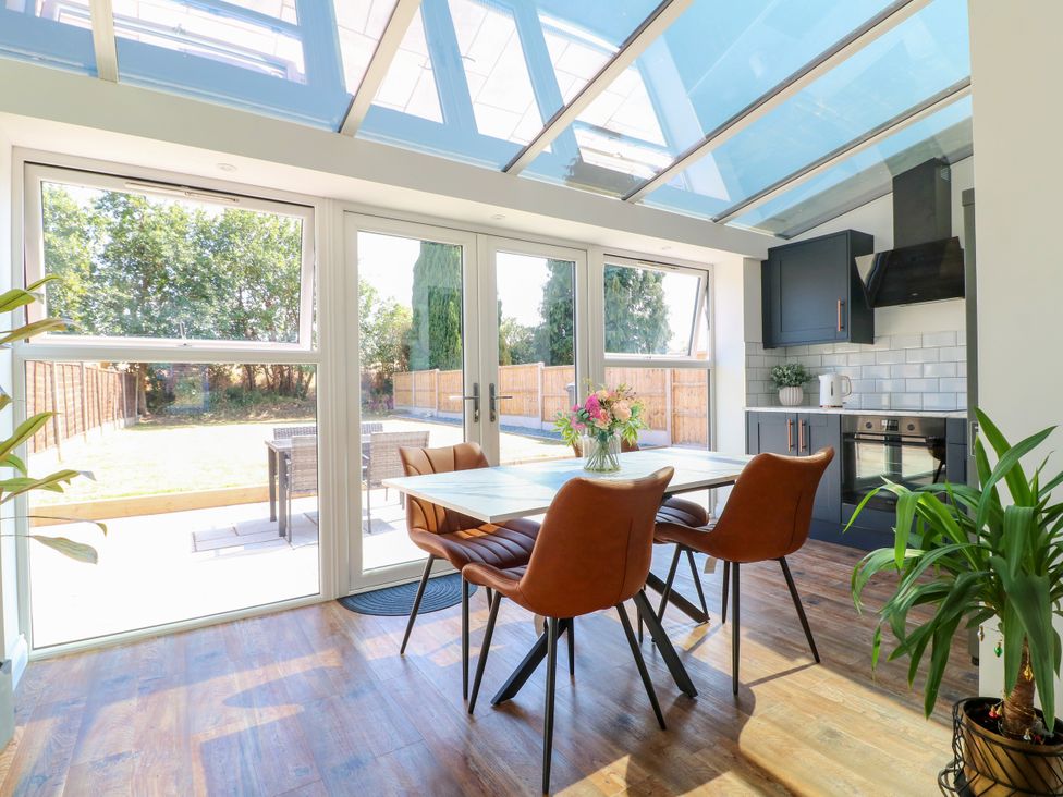 A dining room with a table and chairs at 19 Berry Avenue in Breedon On The Hill