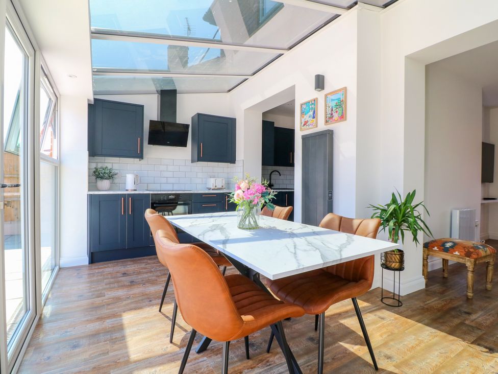 A kitchen with a dining table and chairs at 19 Berry Avenue in Breedon On The Hill