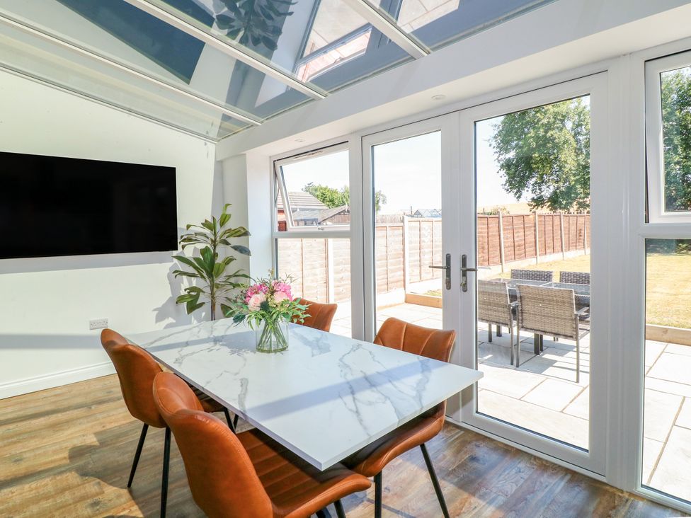 A dining room with a table and chairs at 19 Berry Avenue in Breedon On The Hill