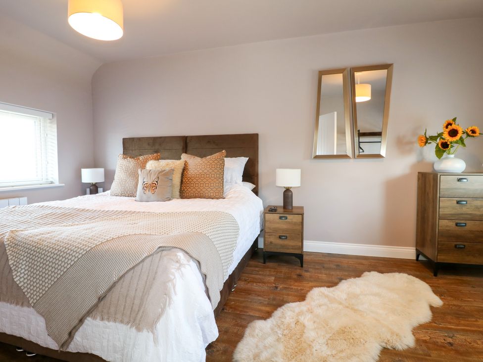 A bedroom with a bed and dresser at 19 Berry Avenue in Breedon On The Hill