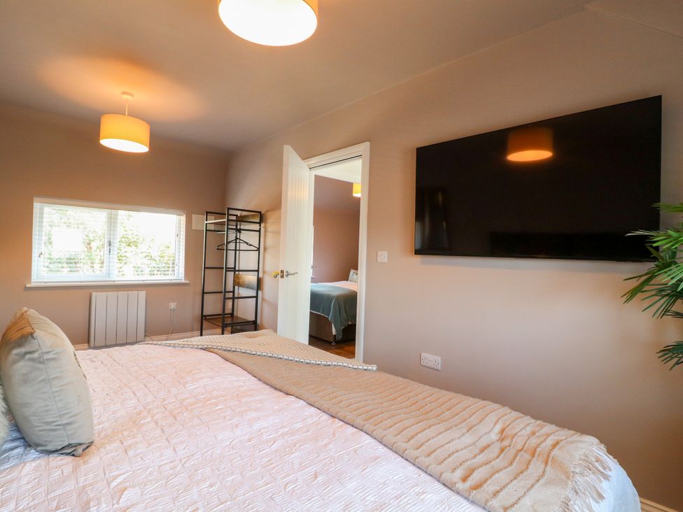 A bedroom with a bed and television at 19 Berry Avenue, Breedon On The Hill