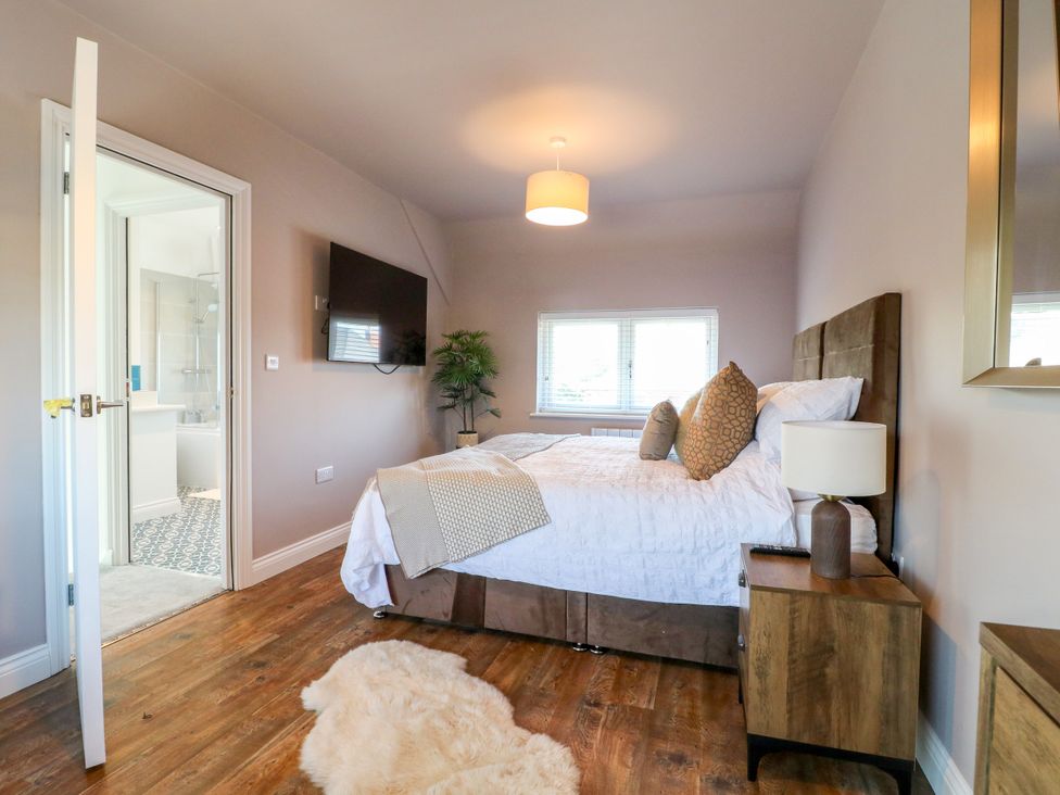 A bedroom with a bed and a television at 19 Berry Avenue in Breedon On The Hill