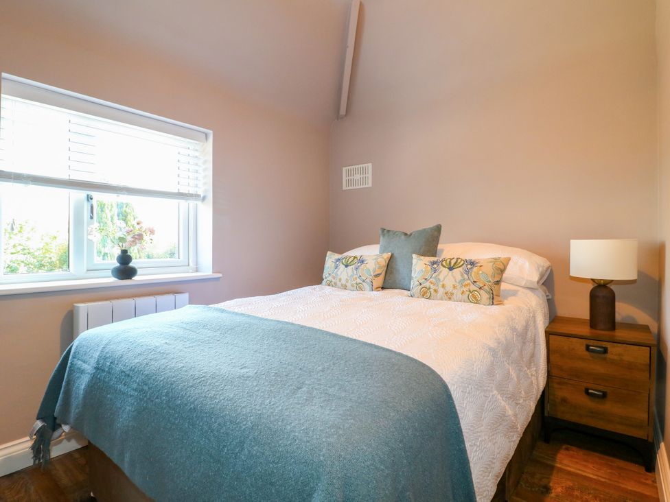 A bedroom with a bed and bedside table at 19 Berry Avenue Breedon On The Hill