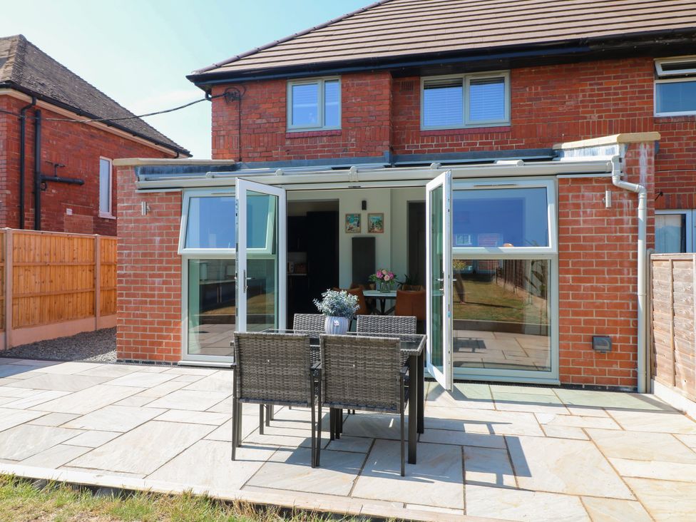 An outdoor seating area with table and chairs at 19 Berry Avenue Breedon On The Hill