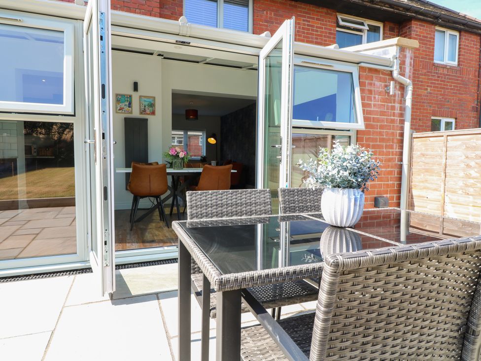 A dining area with chairs and a table at 19 Berry Avenue in Breedon On The Hill