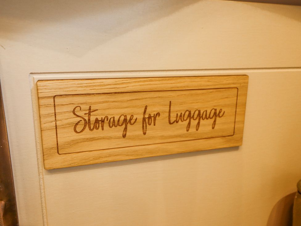 A wooden sign labeled storage for luggage at Twit Twoo Shepherds Hut North Somercotes