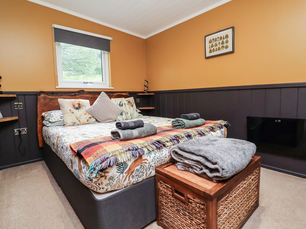 A bedroom with a bed and pillows at Owls Nest Lodge South Molton