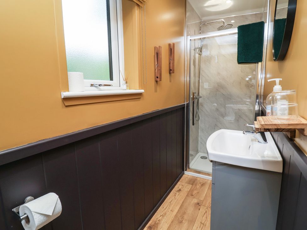 A bathroom with a sink and shower at Owls Nest Lodge in South Molton