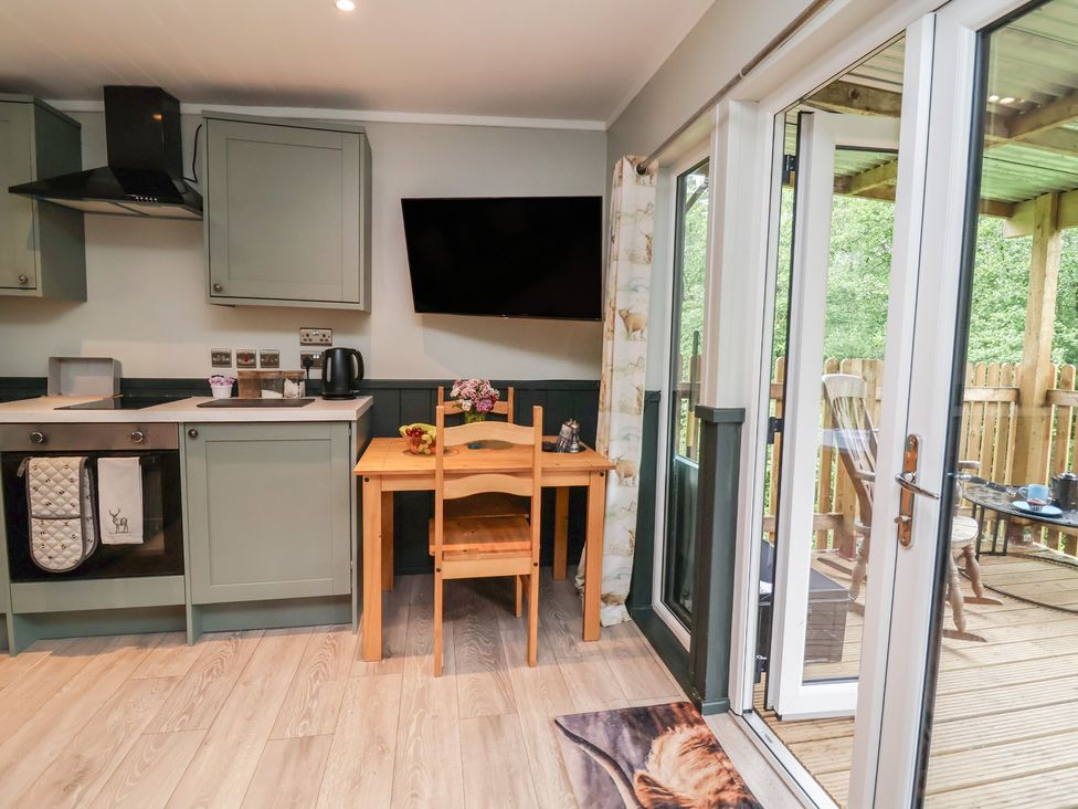 A kitchen with a table and chairs at Robins Nest Lodge in South Molton