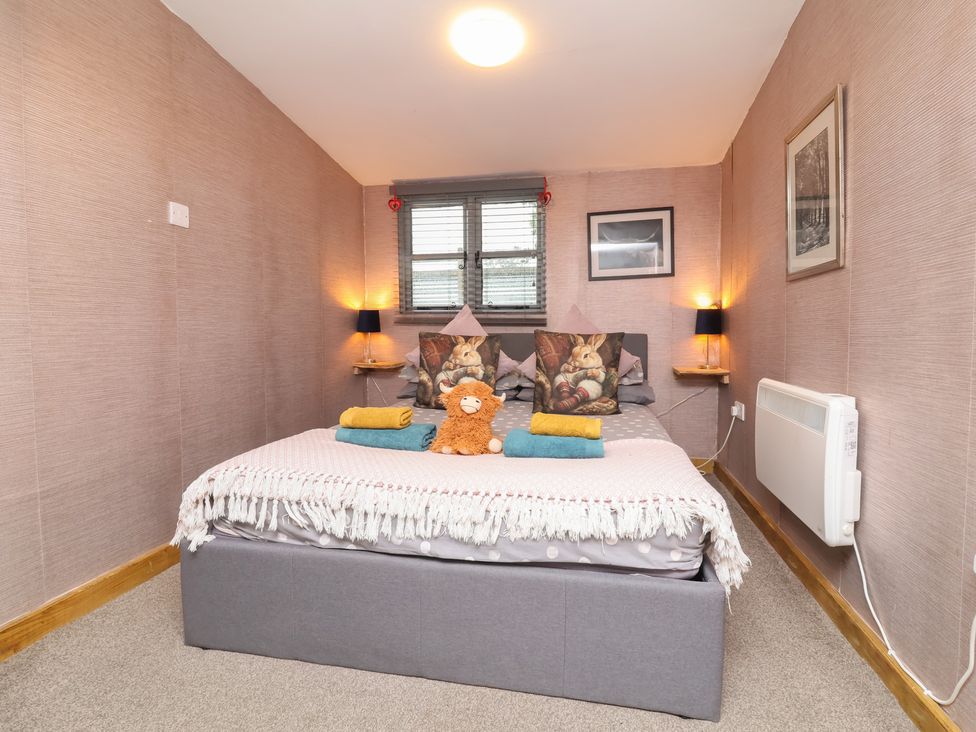 A bedroom with a bed and pillows at Hedgehogs Lodge in South Molton