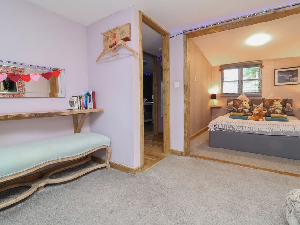 A bedroom with a bed and pillows at Hedgehogs Lodge in South Molton