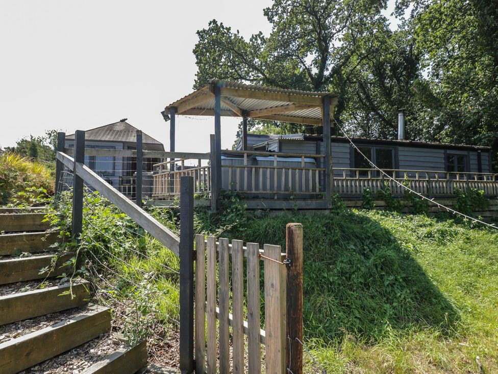 An outdoor area with steps leading to a deck at Hedgehogs Lodge South Molton