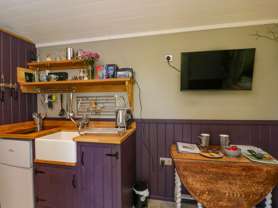 A kitchen with a sink and refrigerator at Valley View Shepherd's Hut in South Molton