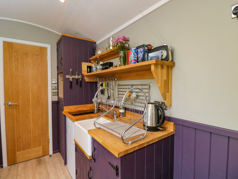 A kitchen with a sink and draining rack at Valley View Shepherd's Hut in South Molton