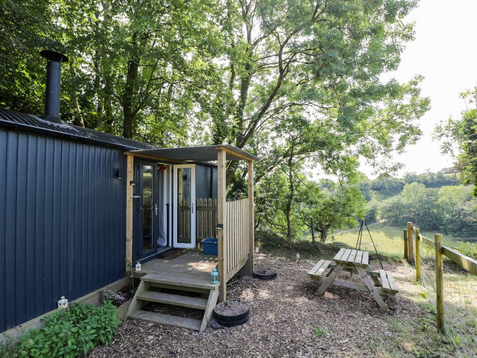 An outdoor area with a picnic table and steps at Valley View Shepherd's Hut in South Molton