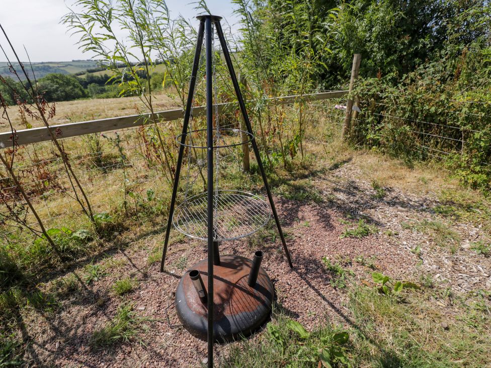 A grill on a stand in a garden at Hares Hideaway Shepherd's Hut South Molton