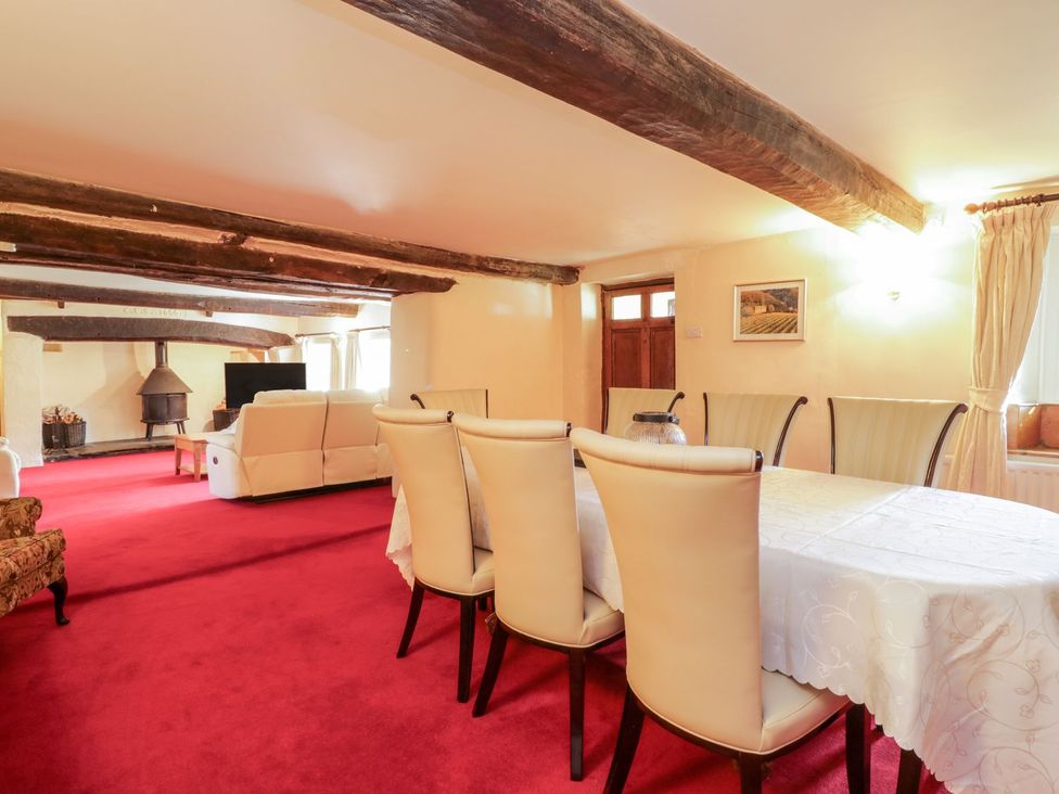 A dining room with a table and chairs at The Farmhouse in Keswick