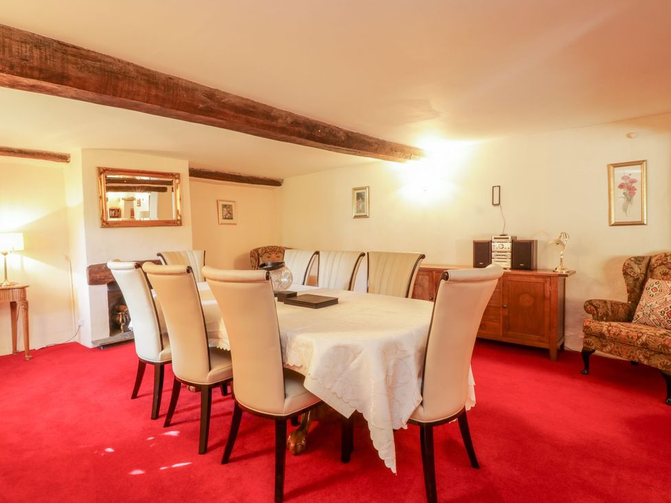 A dining room with a table and chairs at The Farmhouse in Keswick