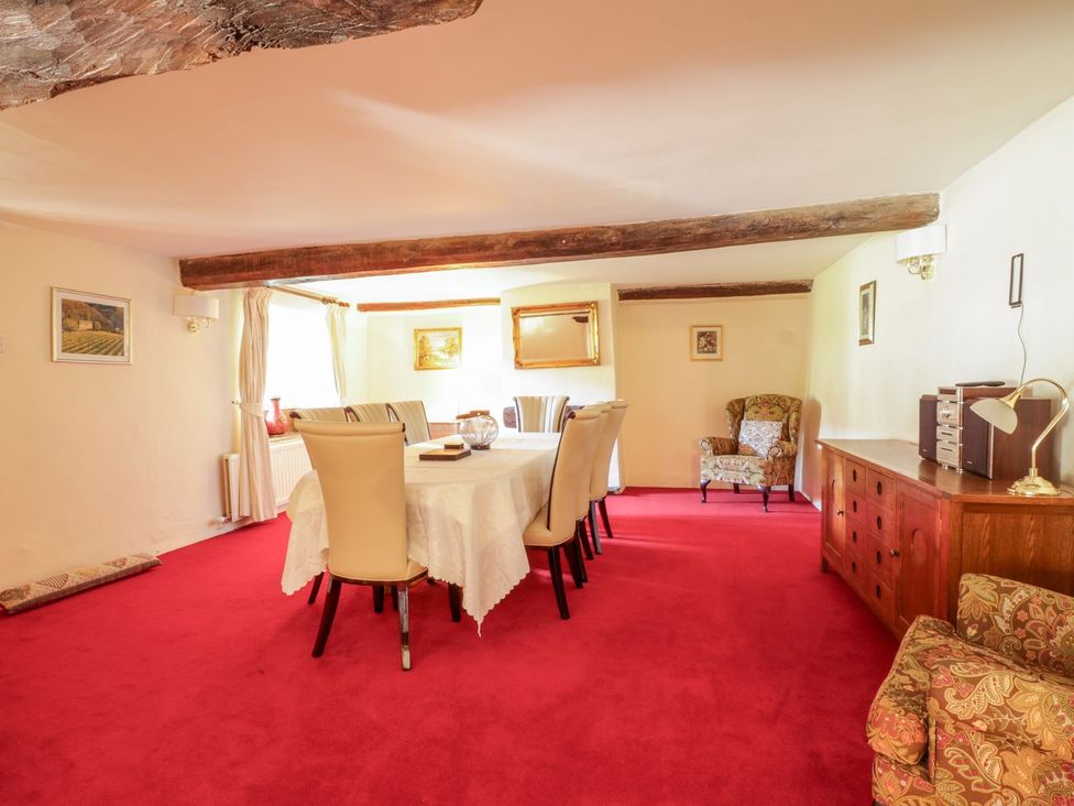 A dining room with a table and chairs at The Farmhouse in Keswick
