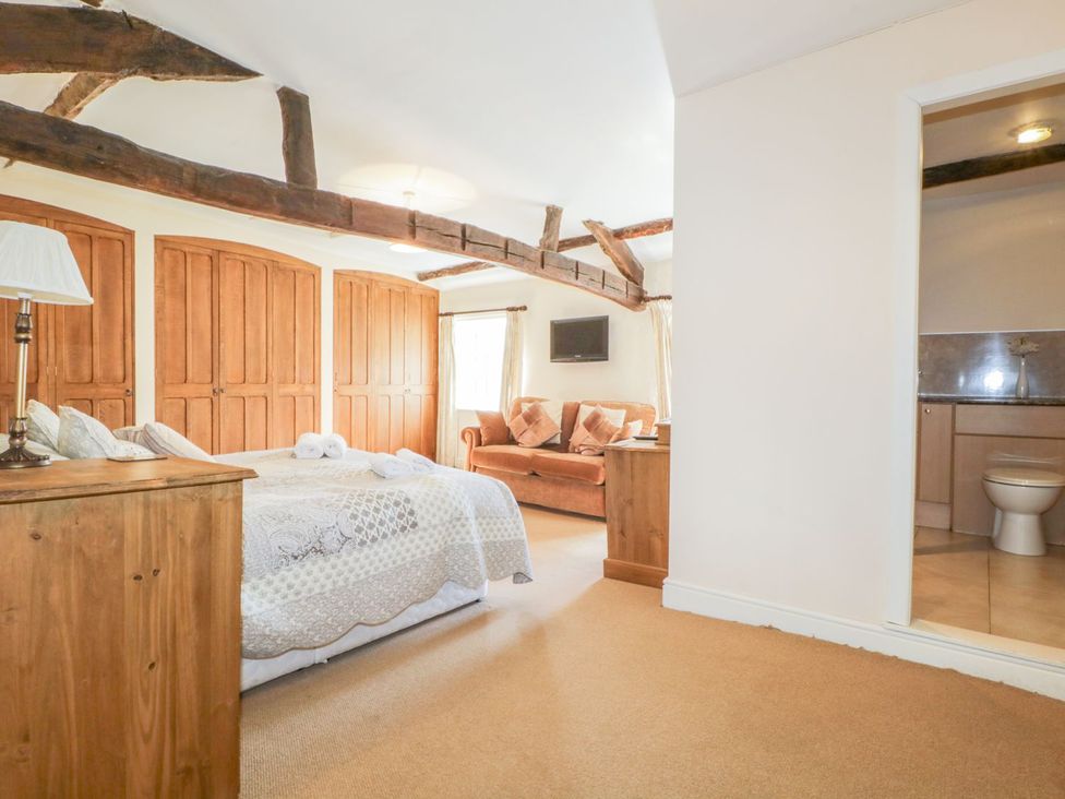 A bedroom with a bed and wardrobe at The Farmhouse in Keswick