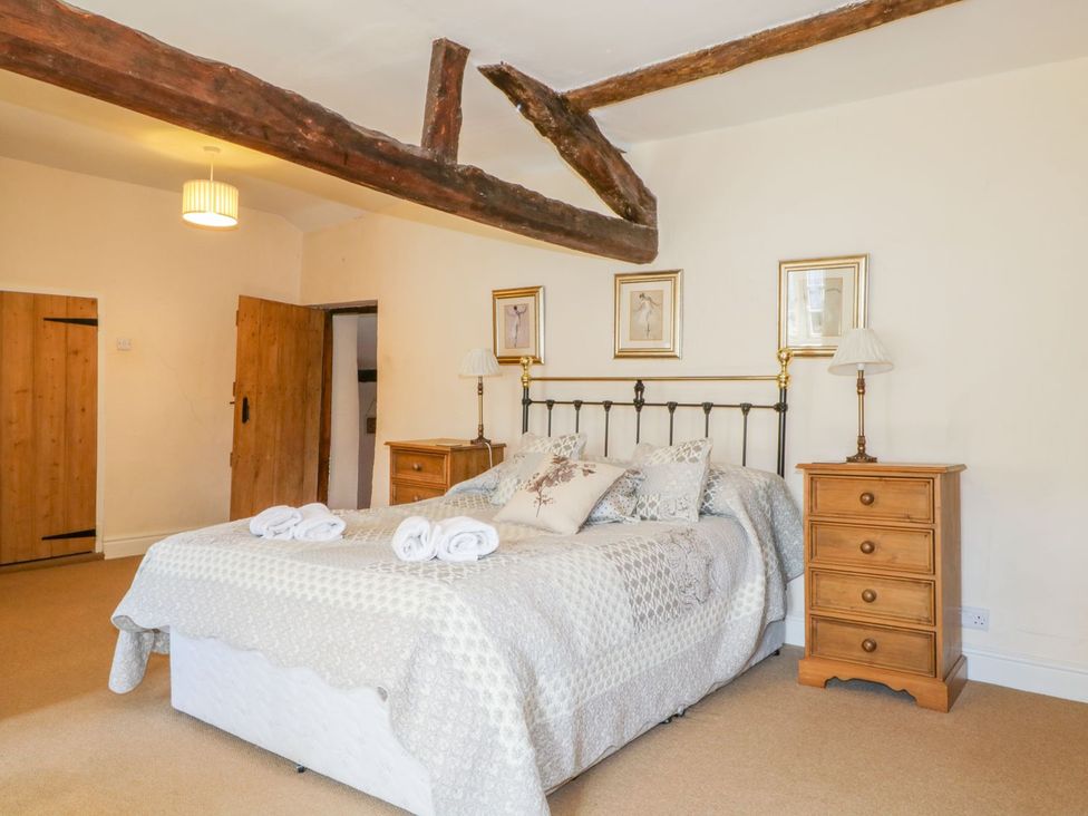 A bedroom with a bed and bedside tables at The Farmhouse in Keswick